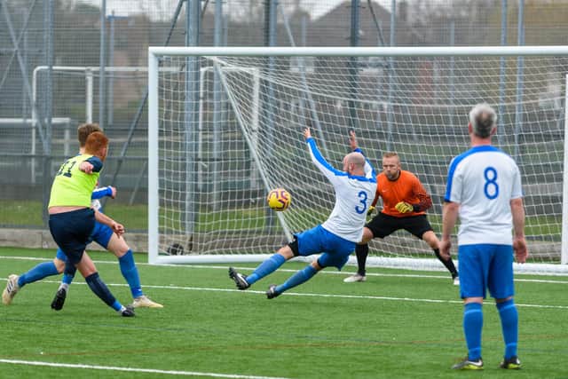 Mitch Frost fires in an effort on the West Wight goal - the keeper couldn't hold the ball and Luke Musselwhite pounced to give Harvest Home the lead in the Hampshire Vase semi-final. Picture: Vernon Nash