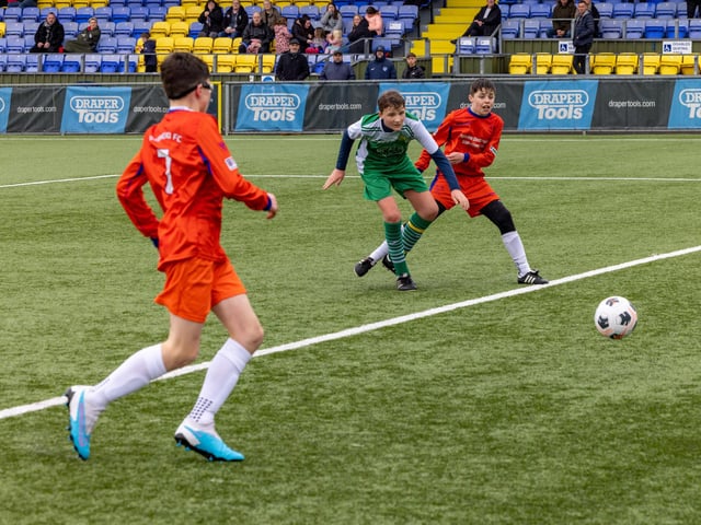 Action from the Under-13 Truman Challenge Cup final between Denmead Youth Lions (orange shirts) and Moneyfields Youth Yellow. Picture: Mike Cooter