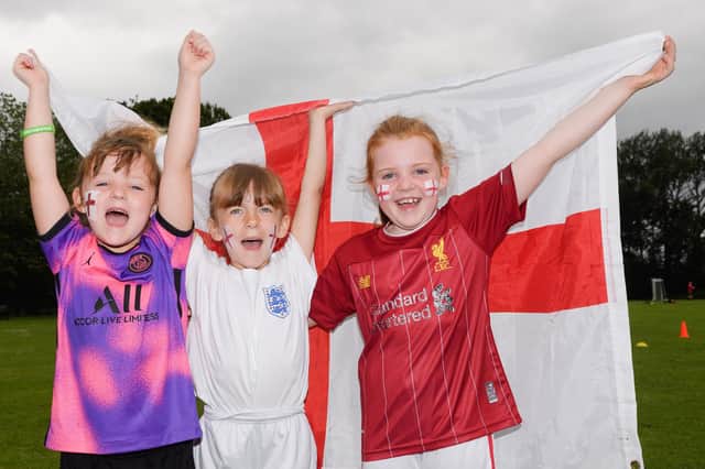 Stubbington Youth FC teams supporting England in the Euro 2020Pictured is: Elisa, Olivia and Mia cheer on England.Picture: Keith Woodland (110721-25)