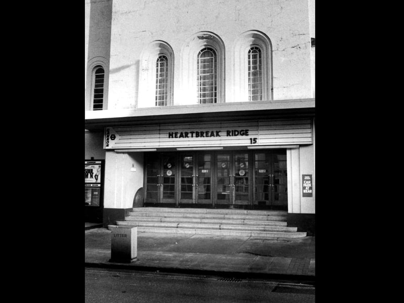 The Empire or later know as Cannon Cinema on East Street Havant in February 1987. Soul Man and Heartbreak Ridge were showing.
In 1986, it was taken over by the Cannon Cinemas chain and re-named Cannon. It was closed on 26th March 1987. There were many protests about this, and other uses such as church or nightclub were hoped for, but nothing happened and the building became derelict. It was demolished in August/September 1994 and a block of flats named Empire Court was built on the site.The News PP3376