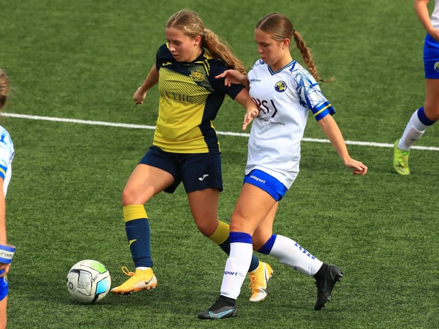 Moneys' Ella Wright  holds off Hawks' Millie McNamara. Picture by Dave Haines