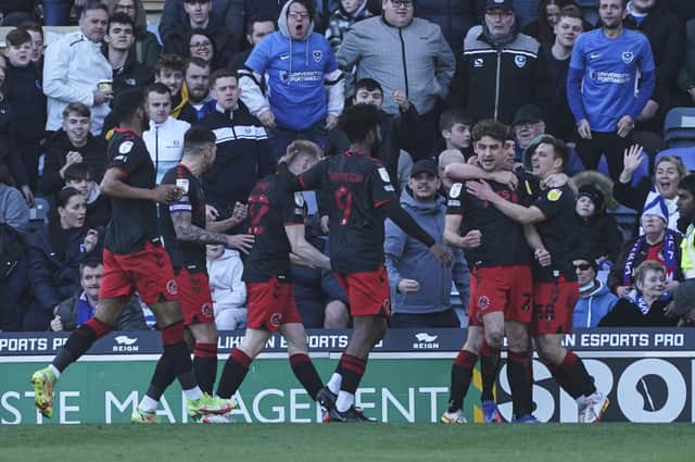 The Fleetwood players celebrate their second goal during the first half at Fratton Park.