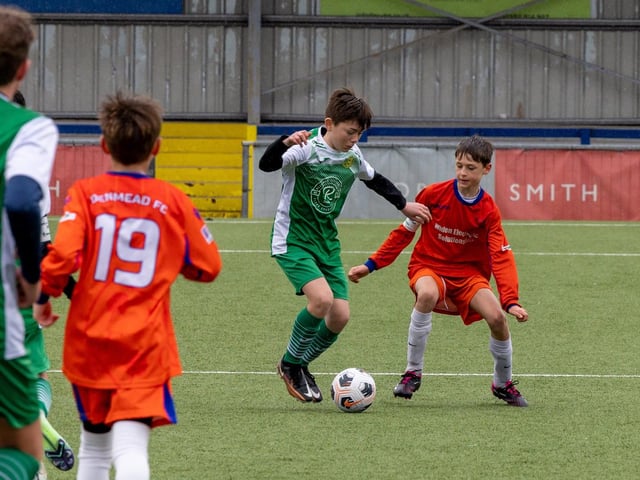 Action from the Under-13 Truman Challenge Cup final between Denmead Youth Lions (orange shirts) and Moneyfields Youth Yellow. Picture: Mike Cooter