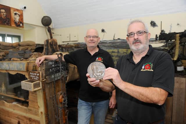Gareth Lewis (left), chairman of the Pompey Pals Museum, and co-founder, Chris Pennycook, inside the museum with the death penny.
Picture: Sarah Standing