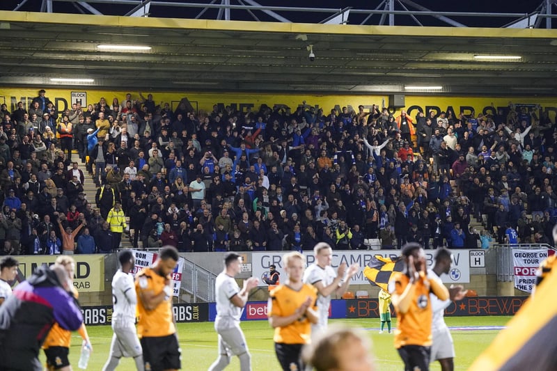 Pompey fans welcome their players to the pitch at Cambridge.