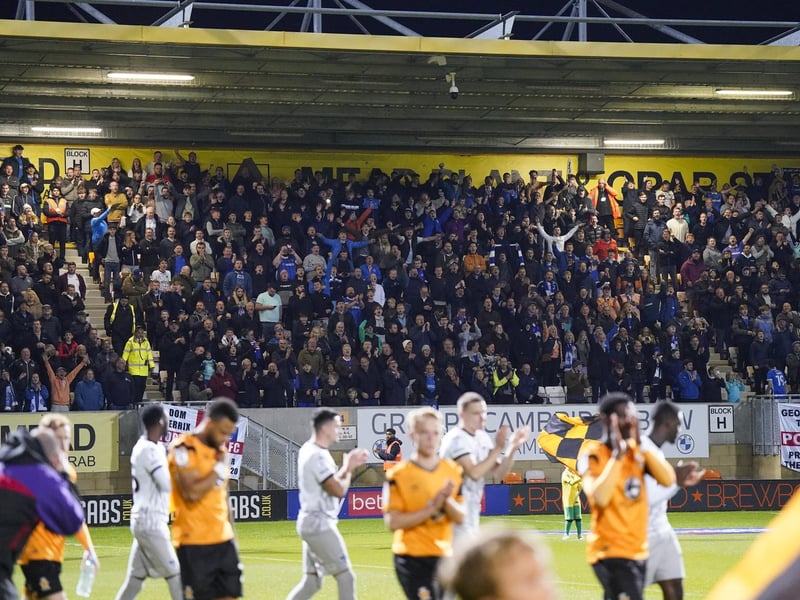 Pompey fans welcome their players to the pitch at Cambridge.