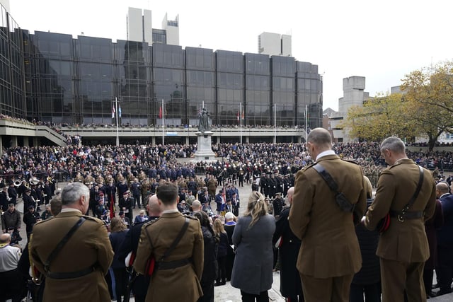 Members of the public, veterans and members of the armed forces in the Remembrance Sunday service and parade in Guildhall Square