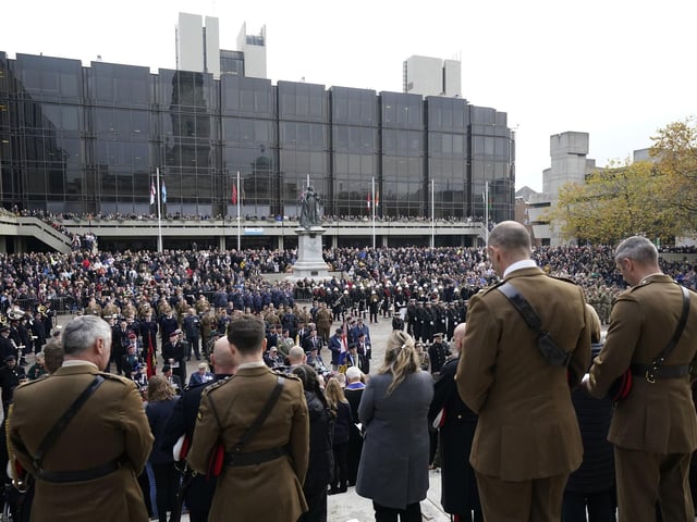 Members of the public, veterans and members of the armed forces in the Remembrance Sunday service and parade in Guildhall Square