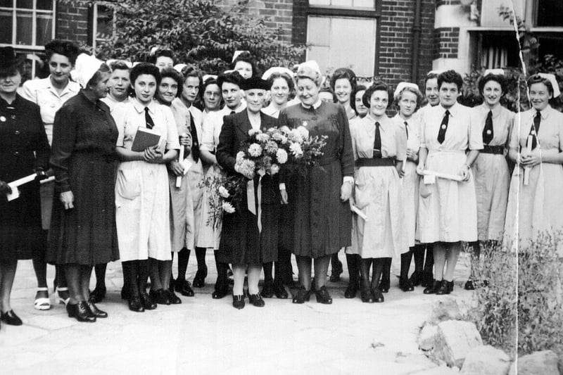 Matron De La Court (right of the lady with flowers) at a presentation at the Royal Hospital in Portsmouth circa 1950.
