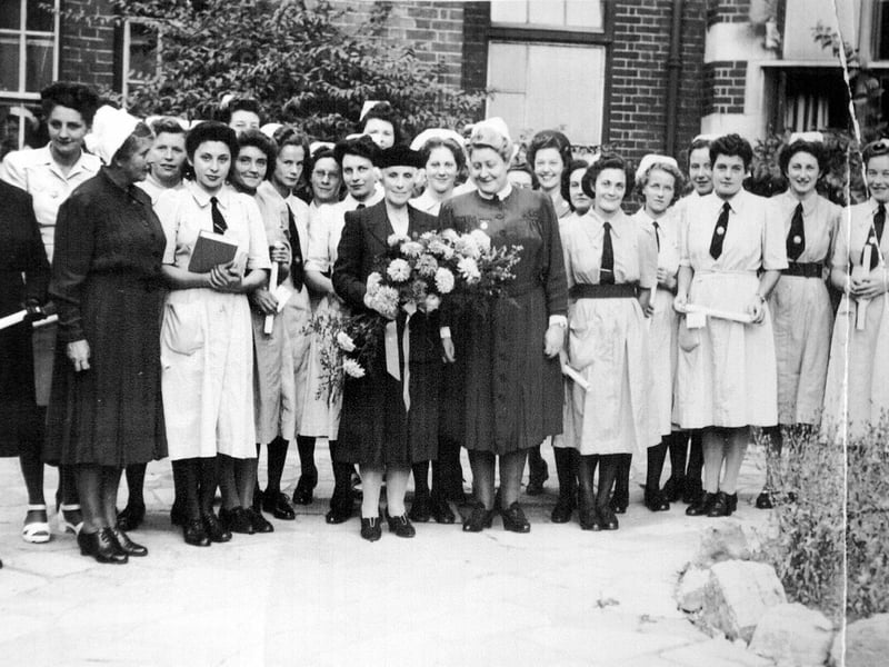 Matron De La Court (right of the lady with flowers) at a presentation at the Royal Hospital in Portsmouth circa 1950.