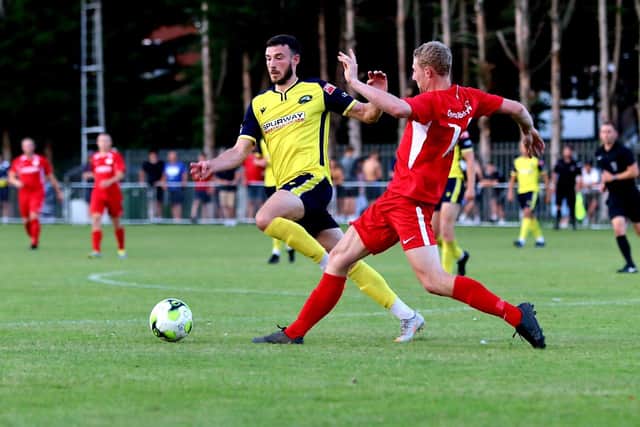 Gosport's Brad Tarbuck (yellow) in action against Horndean. Picture: Tom Phillips