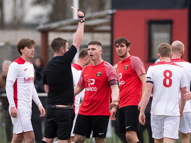 Referee Darren Cooley shows Fareham Town captain Garry Moody a red card for his tackle on Ben Anderson. Picture: Keith Woodland