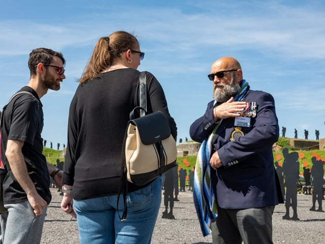 Veteran John explains his medals to visitors to the installation. at the Royal Armouries. Picture: Mike Cooter (280523)