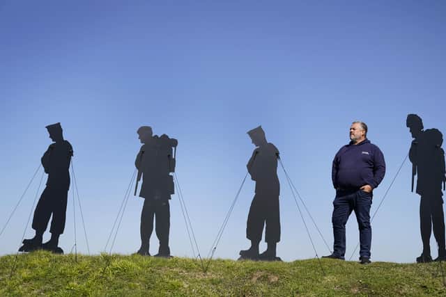 Dan Barton, creator of Standing with Giants, stands next to silhouettes which are part of the Standing With Giants art installation at the Royal Armouries Fort Nelson in Portsmouth. The outdoor installation features life-size silhouettes of the 258 military personnel and civilians who lost their lives in the Falklands Conflict. 
Picture date: Thursday April 20, 2023. PA Photo. See PA story ARTS Falklands. Photo credit should read: Andrew Matthews/PA Wire