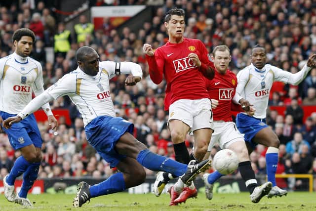 Sol Campbell clears from Manchester United's Cristiano Ronaldo in Pompey's memorable FA Cup triumph at Old Trafford in March 2008. Picture: AFP PHOTO ADRIAN DENNIS