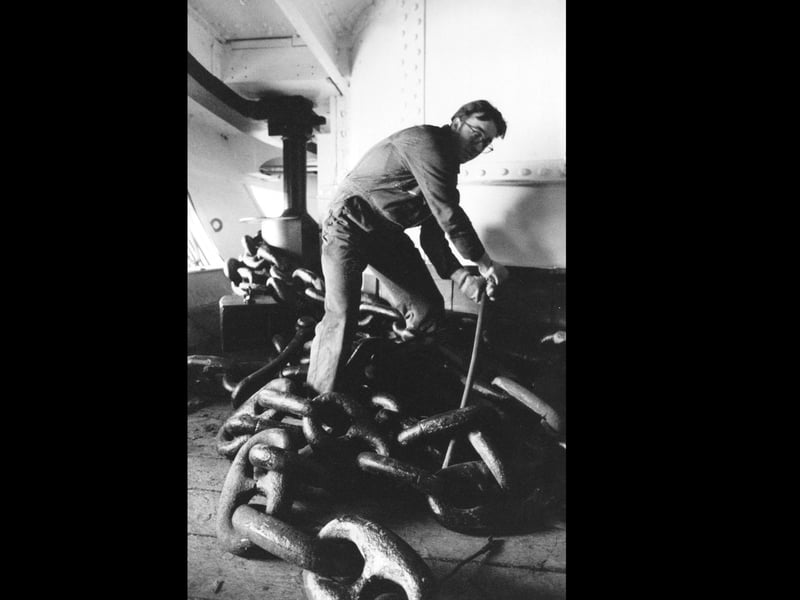 Thomas Etock, a rigger with Alexandra Towing helps slip one of the mooring anchors on board HMS Warrior in January 1994. The News PP4340