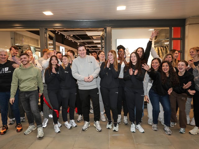 Store manager Eddie Warton, centre, cuts the ribbon with other staff. New Balance shop opens in Gunwharf Quays, PortsmouthPicture: Chris  Moorhouse (271124-12)