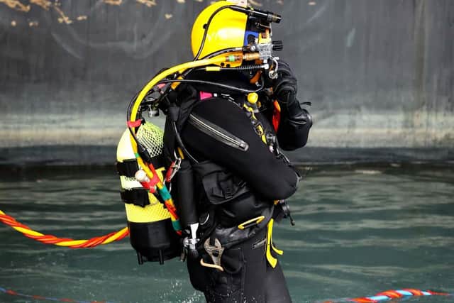 Royal Navy Divers are carrying out work on the hull of HMS Prince of Wales whilst the ship is alonside in HMNB Portsmouth, Hampshire on 10th February 2022.