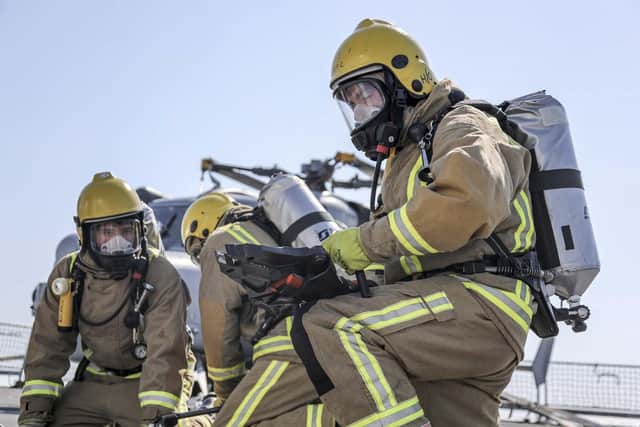 Sailors carry out firefighting training on HMS Defender