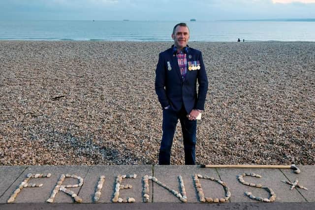 Graham Culton leaves stone messages at Portsmouth seafront.