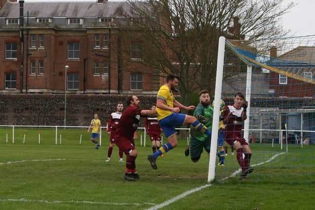 Dale Holmes forces the ball in  from close range for one of his four goals against Netley. Picture: Andy Nunn