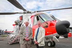 WINGS: From left: Barnbrook systems managing director Tony Barnett and Sir Donald Spiers, then chairman of Farnborough Aerospace Consortium at the 2018 Farnborough International Airshow in front of a helicopter with Barnbrook System's fuel switch