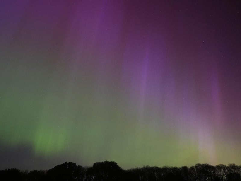 The aurora borealis, also known as the northern lights, glow on the horizon over Basingstoke in Hampshire.