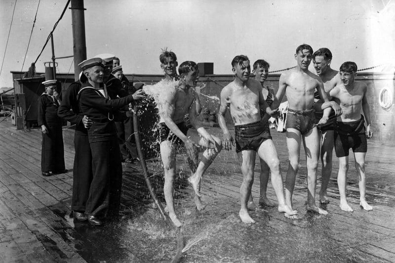 20th August 1936:  Sea Cadets being soaked on board the training ship 'Implacable' in Portsmouth harbour.  (Photo by E. Dean/Topical Press Agency/Getty Images)