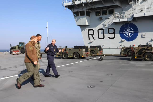 American sailors join their British counterparts on HMS Prince of Wales's huge flight deck