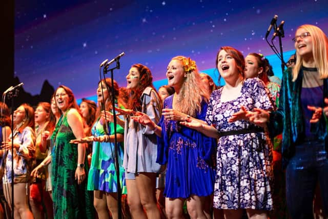 Some Voices choir performing on stage at Outernet, London