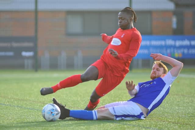 A Denmead player makes a sliding tackle against Sway at Front Lawn. Picture: Martyn White