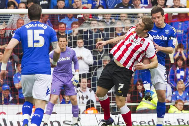 Skipper Jason Pearce battles with Rickie Lambert as Pompey claimed a dramatic point in the 2-2 draw at St Mary's in April 2012. Picture: Barry Zee