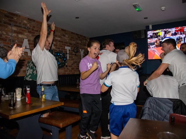 Fans celebrate England scoring against Senegal. Photos by Alex Shute.