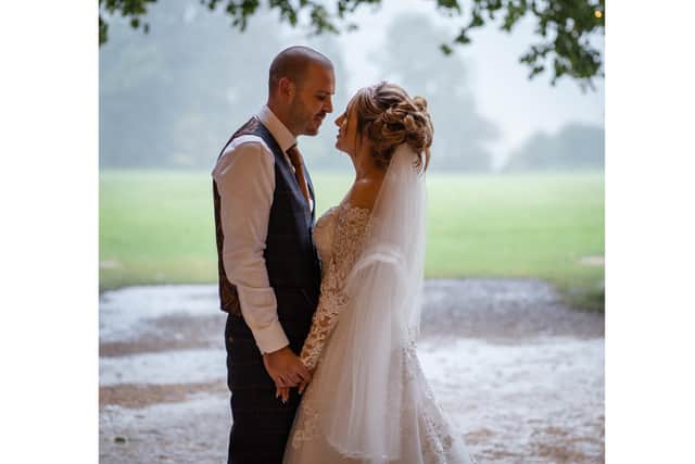 A romantic shot in the rain of Amy and Craig Hughes on their special day.
Picture: Carla Mortimer Wedding Photography