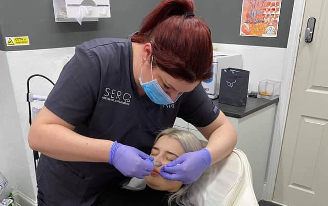 Niki Sulaiman, from Horndean, who runs Sero Aesthetics in Waterlooville performing a dermal filler treatment on a client pre-lockdown. 