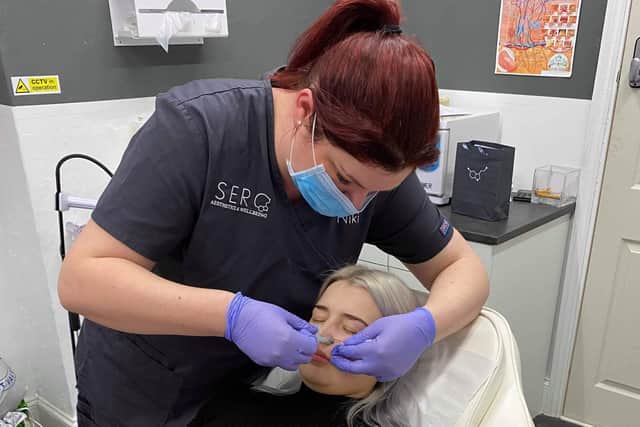 Niki Sulaiman, from Horndean, who runs Sero Aesthetics in Waterlooville performing a dermal filler treatment on a client pre-lockdown. 
