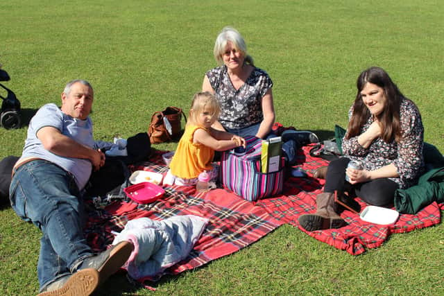 Little Millie, two, out with her grandparents and auntie in the sunshine at Havant park. From left: Barry Partridge, Jane Partridge, and Amanda Partridge. Picture: Emily Turner