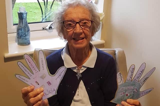 Margaret Leigh-Morgan, resident at Care UK's Pear Tree Court, reads messages sent in by the local community in the 'Hug a Care Home' initiative