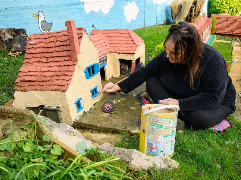 Pictured is: Janet Neil, former owner of the Model Village, restores one of the houses there.Picture: Keith Woodland (100221-11)