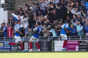 Reeco Hackett (far right) celebrates with the South Stand following his last-gasp equaliser against Plymouth. Picture: Barry Zee