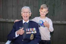 Pictured:  Reginald Plowman with grandson, James, 7.