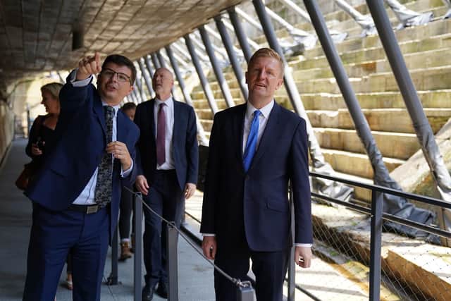 Culture secretary Oliver Dowden, right, with Andrew Baines, deputy executive director of museum operations at The National Museum of the Royal Navy walk underneath HMS Victory during a visit to Portsmouth Historic Dockyard to announce how the final £300 million of the Culture Recovery Fund will be spent. Picture: Andrew Matthews/PA Wire