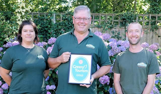Stubcroft Farm Campsite's managing director Simon Green, centre, with operations manager Michaela Rozborilova, left and  Mark Feast, sustainability and accessibility coordinator, right