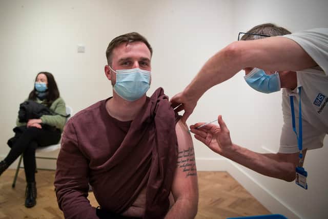 A man gets vaccinated at Gunwharf Quays on January 29, 2022 at a Solent NHS Trust pop-up vaccination clinic. Photo by Finnbarr Webster/Getty Images