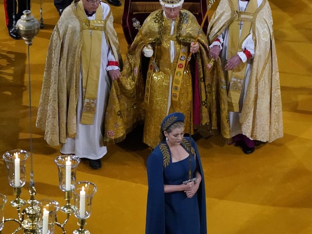 Penny Mordaunt carrying the Jewelled Sword of Offering.