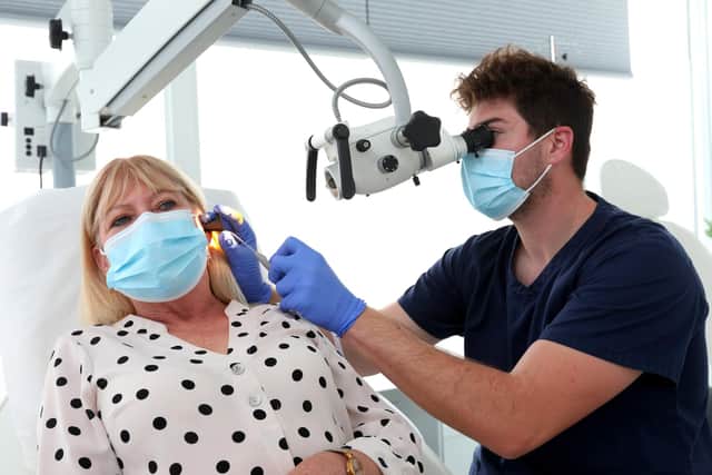 Michael Sadler with his patient, Tricia, during the treatment. Picture: Chris Moorhouse.