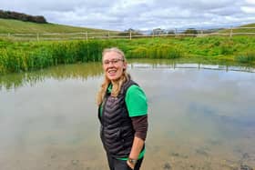 Jan Knowlson, Biodiversity Officer for the South Downs National Park, next to one of the dew ponds.