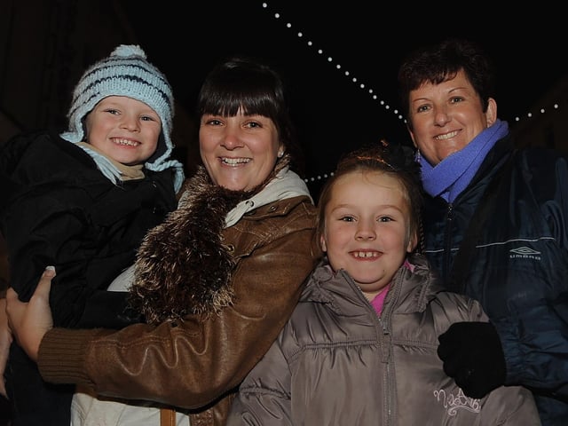 Sam Clarke from Leigh Park with her children Freddie (four), and Mollie (seven), and grandmother Julie Williams (right) watch the Christmas lights switch on in Commercial Road in 2009. Picture: Ian Hargreaves (094172-5)