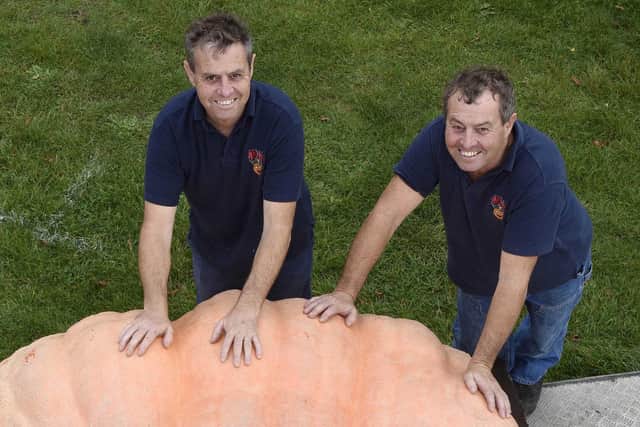 Pictured: Ian and Stuart Paton. A pair of twins have set a new record for the UK's biggest pumpkin with a gourd that weighs as much as a Fiat 500.It weighs 2,656lbs. Picture: Solent News & Photo Agency.