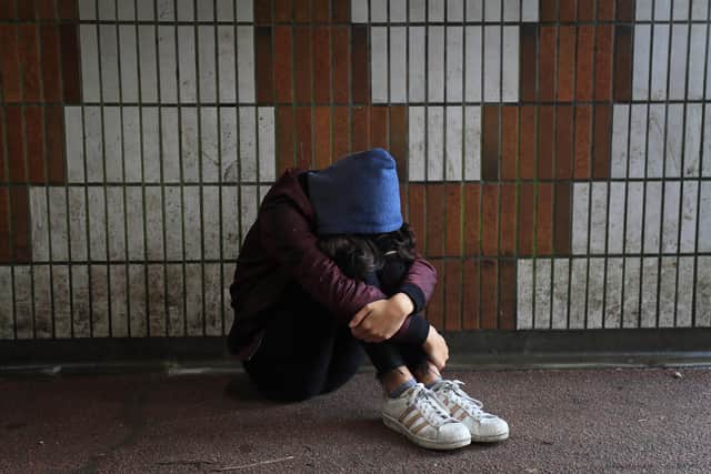 Picture posed by a model of a teenage girl showing signs of mental health issues. Photo: Gareth Fuller/PA Wire